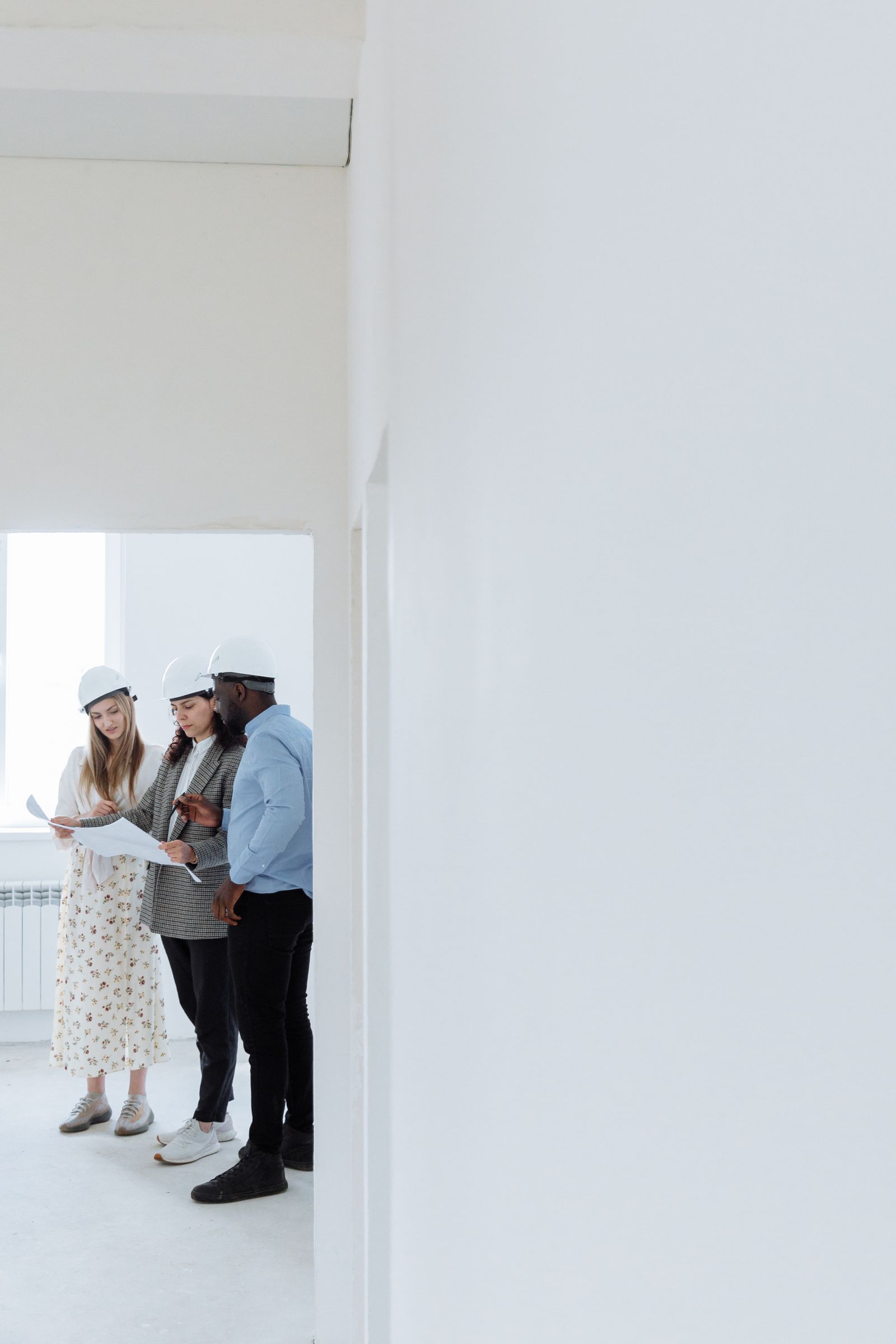 Two people going over drawings inside a house that is being remodelled